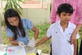 The doctor is taking blood from primary student.